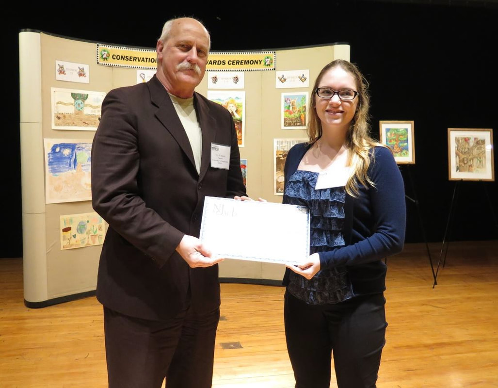 Tony DiLodovico, NJACD President, presents Renee Parisi with a $1,500 Memorial Conservation Scholarship check